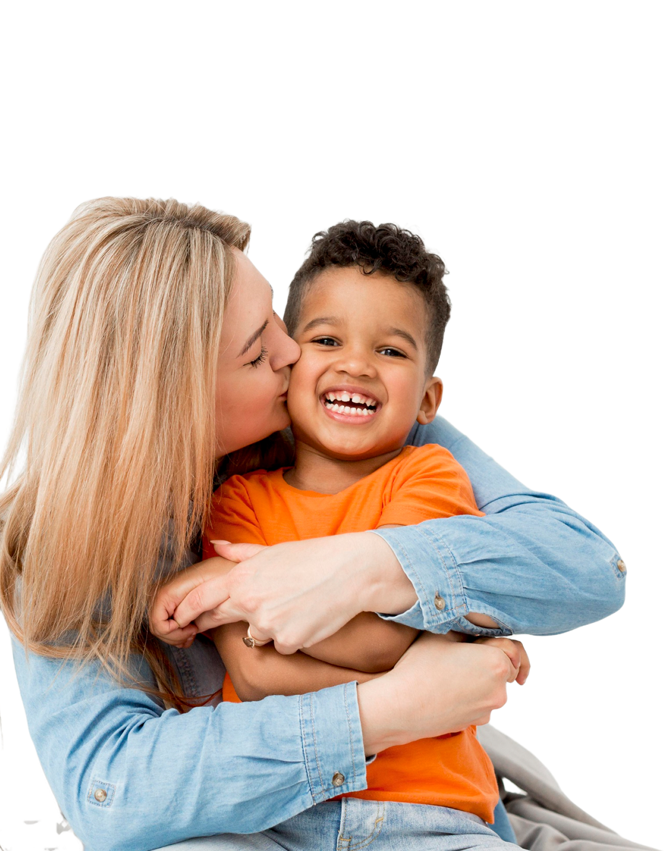 A woman with light hair lovingly kisses a smiling young boy on the cheek. The boy, wearing an orange shirt, is joyfully embraced against a black background.