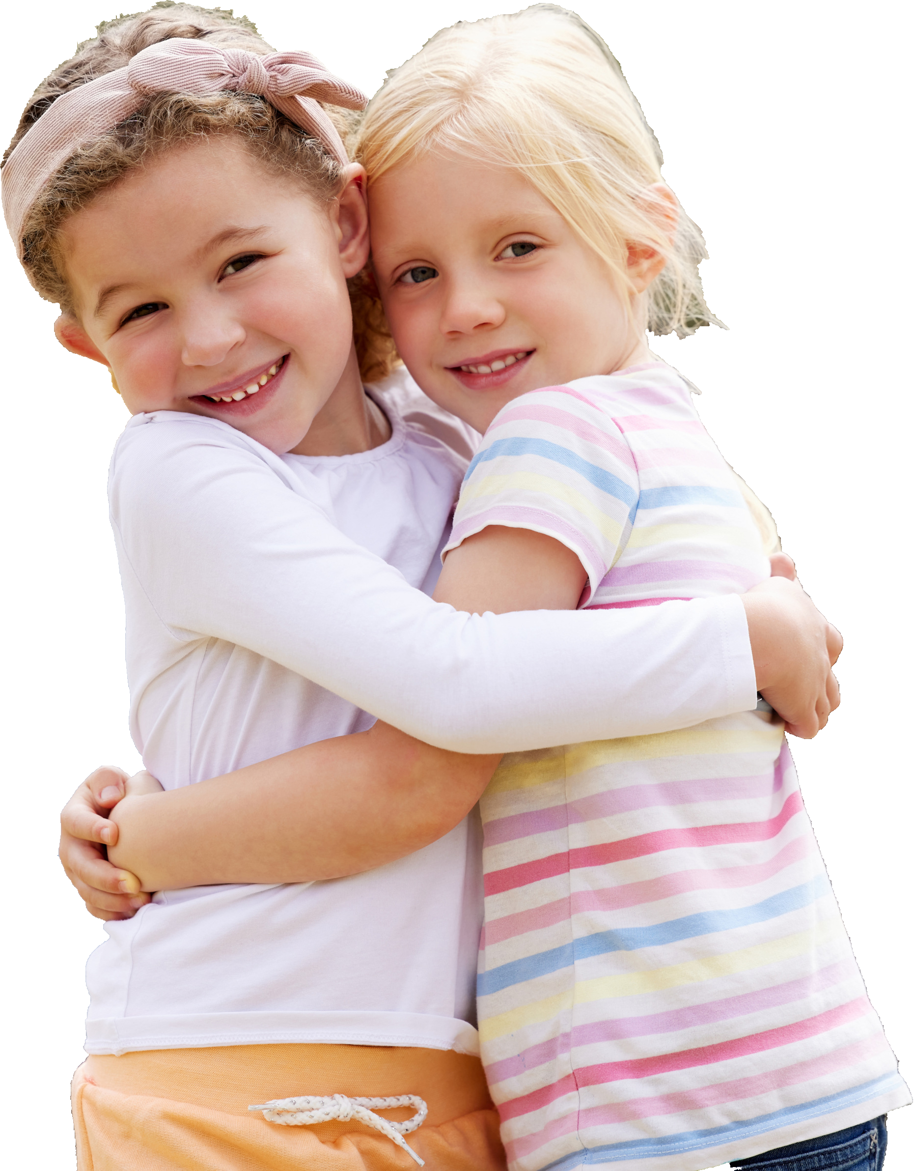 Two smiling children hugging against a black background. One wears a white shirt; the other has a striped shirt. They convey joy and friendship.