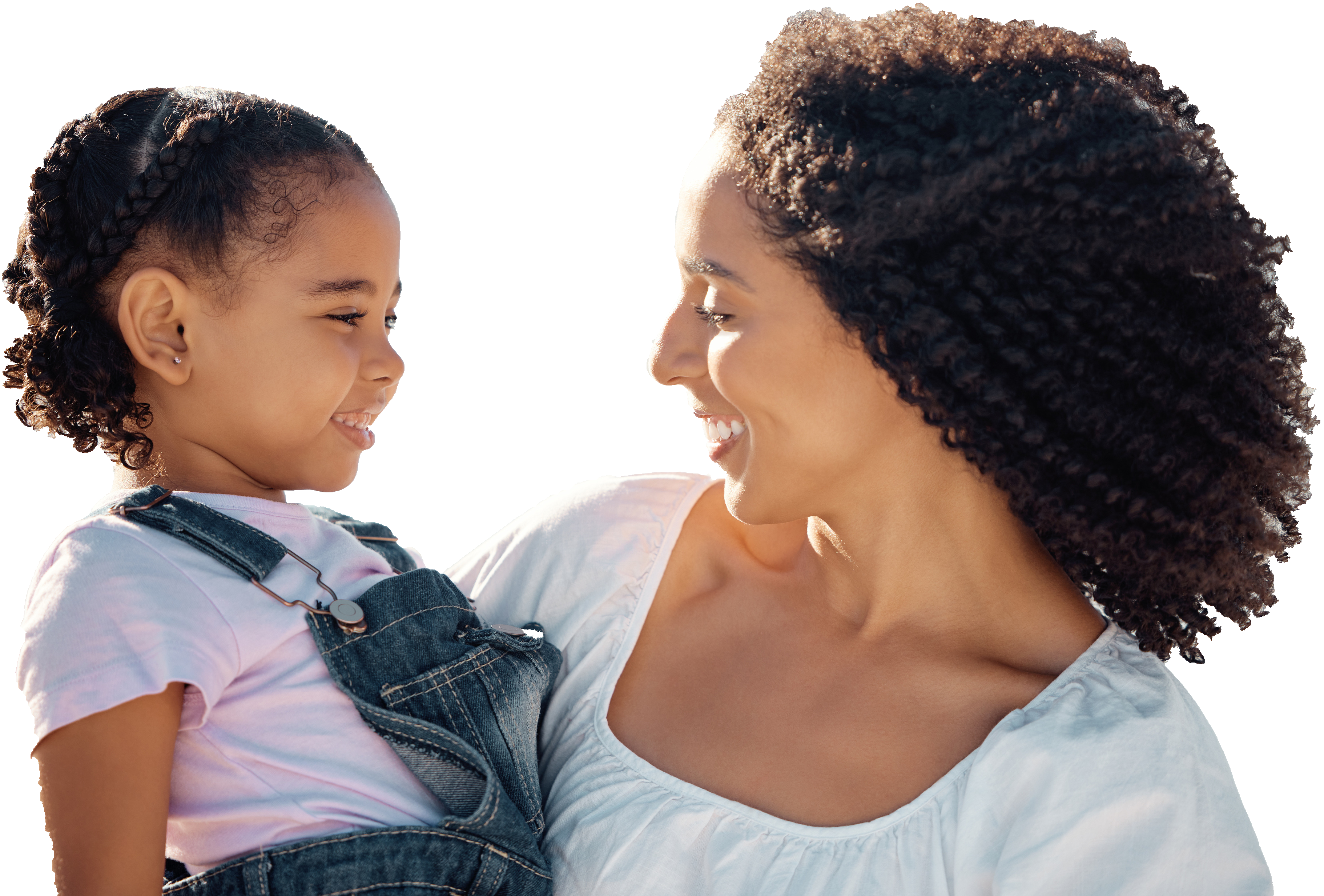 A mother and daughter share a joyful moment, gazing at each other with smiles. The mother holds the daughter, both exuding warmth and affection.
