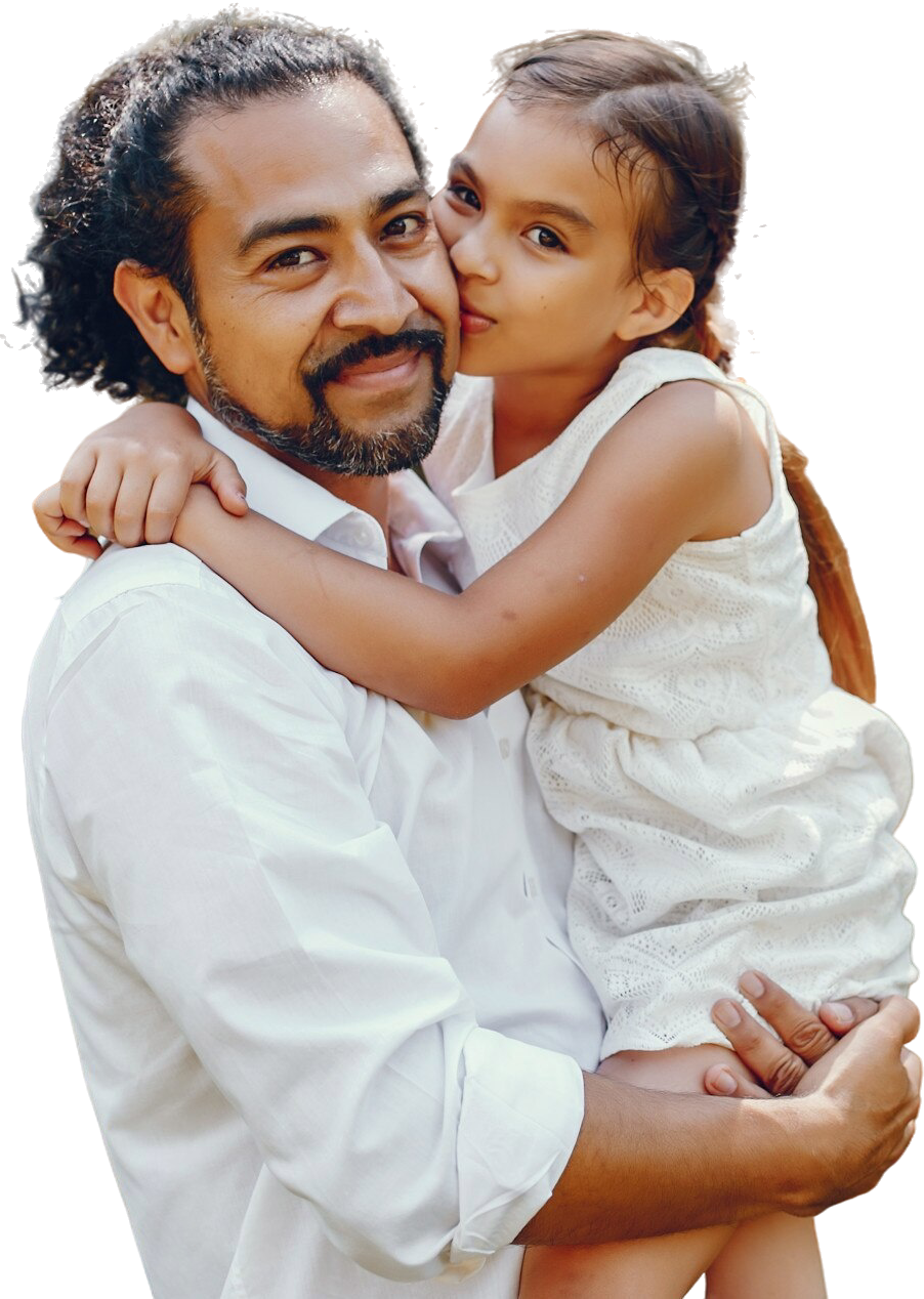 Father and young daughter in white clothing embrace warmly; she kisses his cheek, both smiling, conveying love and joy. Black background.