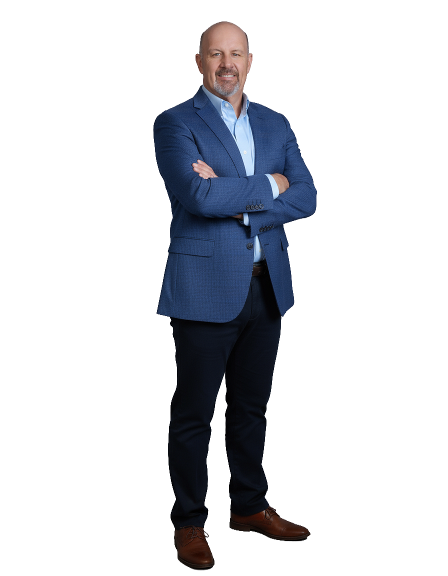 A man in a blue blazer and black pants stands confidently with arms crossed, smiling against a black background. He wears brown shoes, conveying professionalism.